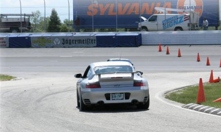 Alan Cady
2003 911 GT-2. Water cooled, 6 Cyl, Twin turbo, 456 HP, 6 speed manual,
Tires 235/40 zr 18" front, 315/30 zr 18" rear, Ceramic Brake Discs.
0-60..3.6sec, 1/4 mile 11.7 @118mph. Top speed 195.(car&driver). Ground
clearance is about 2-1/2" and suspension is very stiff. The car is a rocket
and handles just as well. If you want to go faster, you will need a McLaren
F1 or an Enzo.
