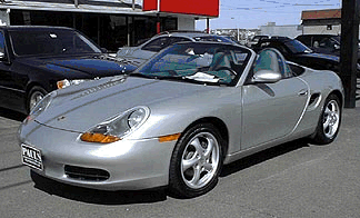 Berthold Langer
Berthold's 1999 Boxster

"This car is coming back to the dream for me. I bought my first Porsche at the tender age of 19 1/2 in 1979. It was an 8 year old, grass green, Porsche 911T. I got lots of laughs for that color, but loved it nevertheless, specially the carburetor sounds at traffic lights. :-) Then one day, on that lovely German Autobahn, I almost left this green earth trying to avoid a French 2CV (Duck) in the 3rd lane. Driving the Toy was never the same for me thereafter and so it had to go. :-( Exactly 25 years later I bought my second Toy. I decided it was time, the dream was lost for too long. Though it is not quite a 911, I enjoy driving the Toy with the top down immensely. And, did you notice? I still can't quite stay away from that green color, but this time it is a very special one. Don't you agree? :-)"- Berthold
