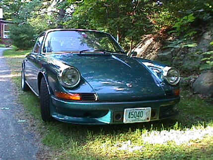 Bob Tucker
73 911 T coupe - Over the 8 years I have owned this VERY fun car it has seen many modifications. It's as much fun to work on as it is to drive. The paint work was first in '96, color is Amazon Green. The original 2.4 L CIS engine was replaced with a basically stock '78 3.0 two years later. It's current configuration is:

Engine: '78 3.0 L 9.5:1 CR, GE-60 cams, ported and polished, Weber IDA 40, MSD 6AL ignition unit with Blaster coil, although not dyno'd (yet) power output is approx 250 HP.

Transmission: 915 with updated hubs and syncs with low ratio differential, short shift kit.

Brakes: '87 Carrera calipers front and rear with cross drilled rotors and Pagid orange pads.

Suspension: 23 mm front and 30 mm rear torsion bars with adjustable spring plates and stiff bushings all around, 22 mm front and 19 mm rear anti-sway
bars.

Body: Weight 2400 lbs (that's without me), RSS front air dam, 2 front oil coolers (one fender and one front), Sparco Evo 2 drivers seat and Recaro SRD recliner both with 6 point Schroth harnesses.

Wheels: Street- Fuchs 6 and 7 X 16 with Yokohama 205/45 16 AVS Intermediate, Track Cookie Cutter 6 and 7 X 15 with Michelin 205/50-15 Sport Cup.
